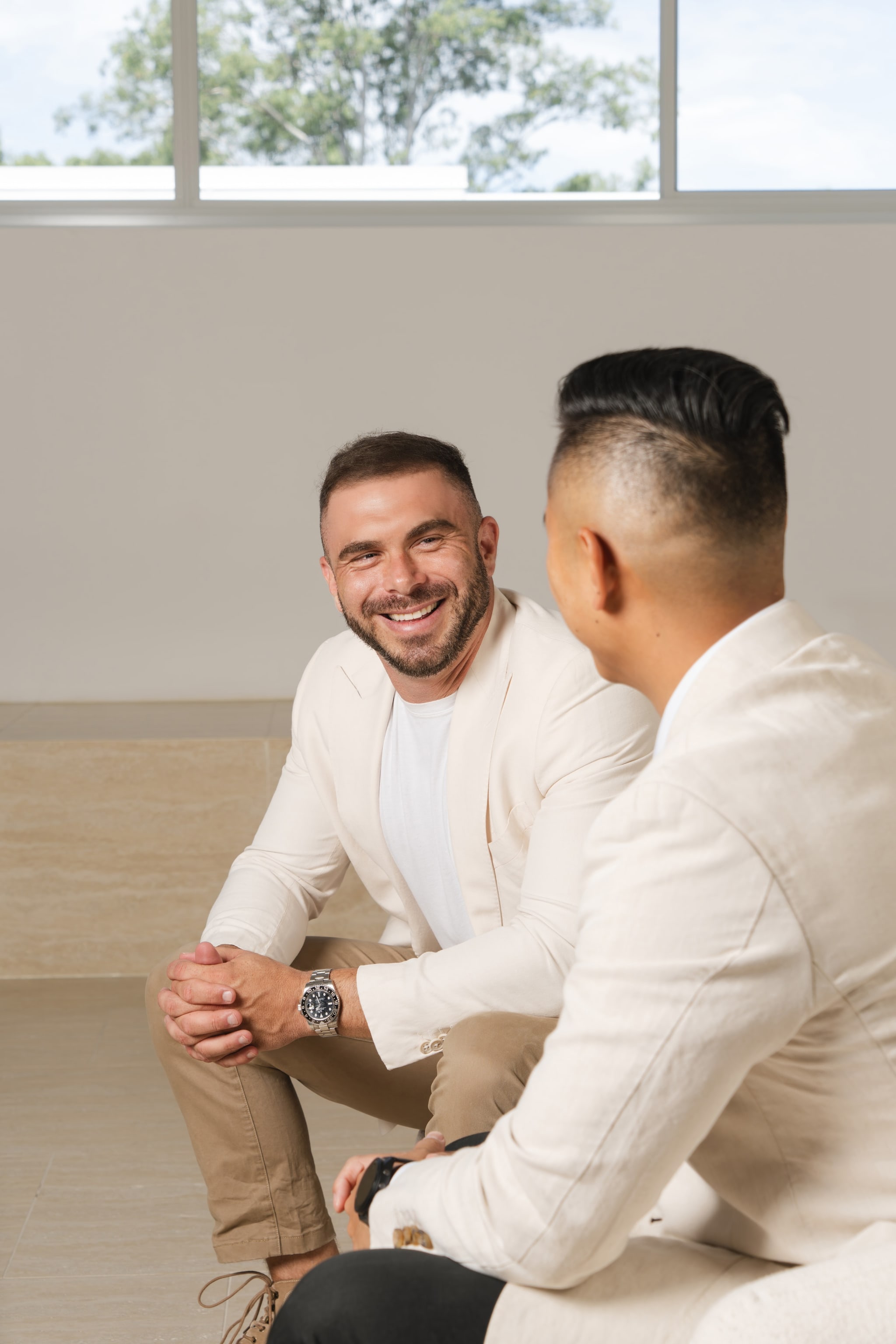 Two team members in cream tones, one smiling at camera. Space Property